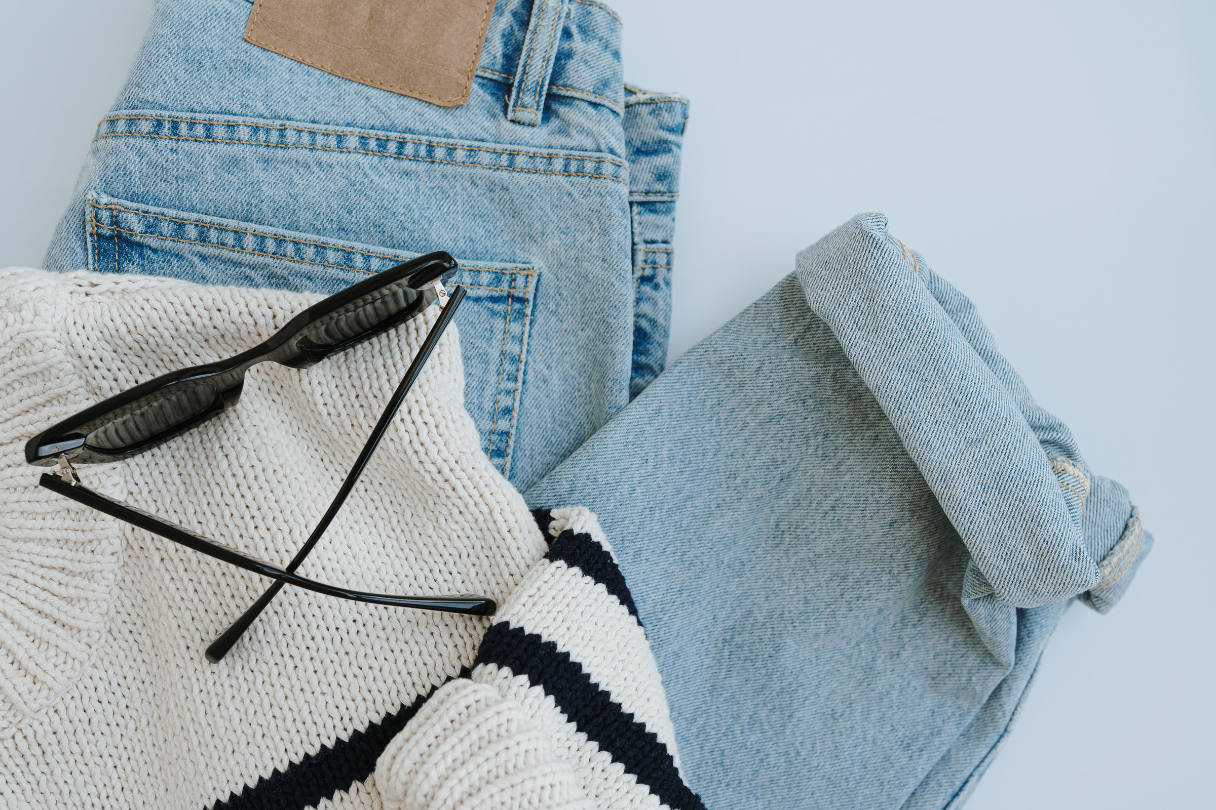 Jeans, Sweater, and Sunglasses Flatlay